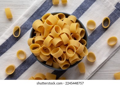 Raw Uncooked Pasta Calamarata in a Bowl, top view. Flat lay, overhead, from above. - Shutterstock ID 2245448757