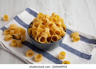 Raw Uncooked Pasta Calamarata in a Bowl, low angle view. - Shutterstock ID 2245449953