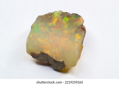 Raw Uncut Shiny White Colorful Ethiopian Opal Crystal Stone Close Up Macro Isolated On A White Surface 