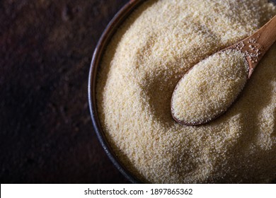 Raw Unprepared Semolina Flour Also Known As Rava Powder In Bowl. Raw Unprepared Semolina In Bowl And Spoon Close-up.