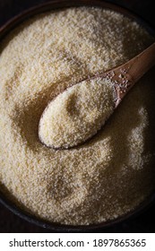 Raw Unprepared Semolina Flour Also Known As Rava Powder In Bowl. Raw Unprepared Semolina In Bowl And Spoon Close-up.