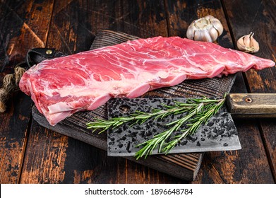 Raw Veal Brisket Meat On Short Spare Rib With Butcher Knife. Dark Wooden Background. Top View.