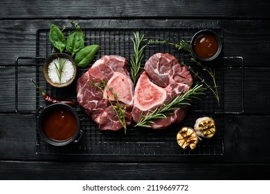 Raw veal Ossobuko steak with bone. Meat. On a stone background.