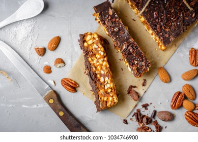 Raw vegan energy bars with dates and nuts and chocolate frosting. Homemade healthy snack sweets. - Powered by Shutterstock