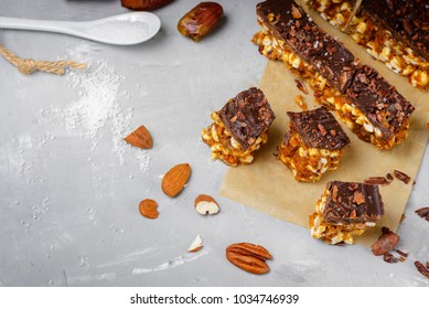 Raw vegan energy bars with dates and nuts and chocolate frosting. Homemade healthy snack sweets. - Powered by Shutterstock