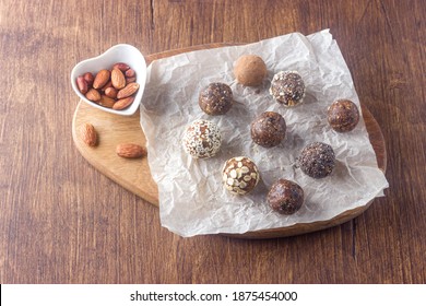 Raw Vegan Healthy Energy Balls With Oatmeal, Chia Seed, Coconut Flakes, Cocoa, Almond, Peanuts And Dried Fruits On Dark Wooden Background. No Cook Energy Bites.