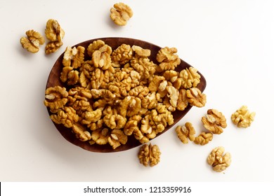 Raw Walnuts On Wooden Tray On White Background Isolated With Copy Space. Overhead Image