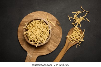 Raw wheat noodles in wooden bowl, top view - Powered by Shutterstock