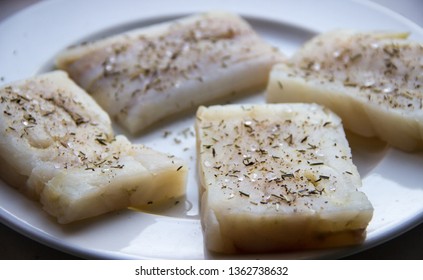 Raw white fish fillet in spices on a plate - Shutterstock ID 1362738632