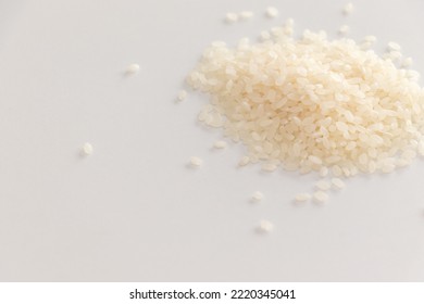 Raw White Rice Grains On White Table