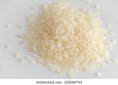 Raw White Rice Grains On White Table