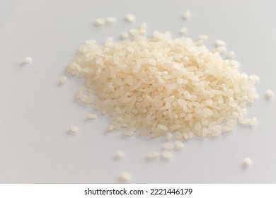 Raw White Rice Grains On White Table