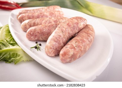 Raw White Sausage On A White Plate. Composition With Traditional Polish White Sausage, Easter Delicacy. 