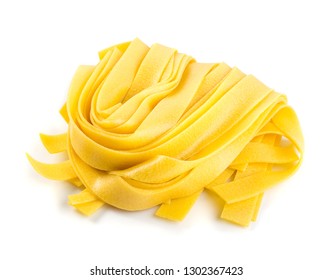 Raw yellow italian pasta pappardelle, fettuccine or tagliatelle close up. Egg homemade dry ribbon noodles, long rolled macaroni or uncooked spaghetti isolated