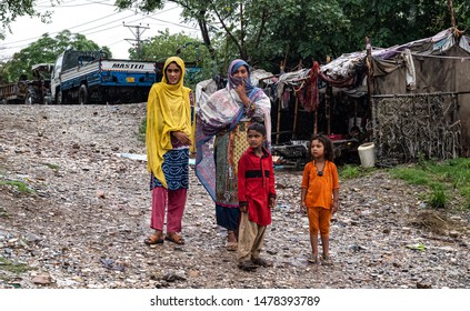 Rawalpindi, Punjab/ Pakistan- August 10, 2019: A Family Stands In Front Of Their Tent Home