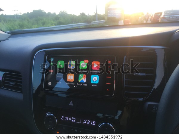 Rawang, Malaysia - June 26, 2019: Apple CarPlay\
main screen in a modern car dashboard. CarPlay is an Apple standard\
that enables a car radio to be a display or a controller for an\
iPhone or iPod.