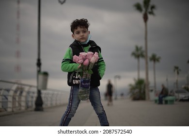 Rawche, Beirut Lebanon - December ‎28 2020 : A Syrian Refugee Child Selling Roses In Beirut