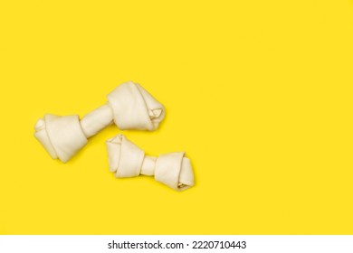 Rawhide Bones On A Yellow Background With Copy Space