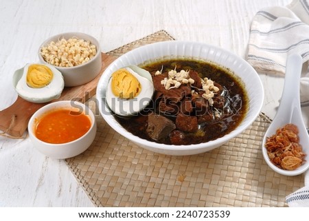 Rawon is Beef Black Soup Originally from East Java, Indonesia.served with salted egg,bean sprouts,and chilli sauce 