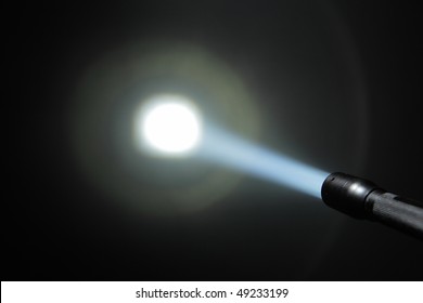 ray of pocket flashlight and projection on the wall