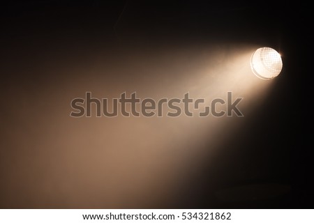 Ray of scenic spot light over dark background, stage illumination equipment