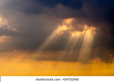 A ray of sunlight breaking through dark clouds.
