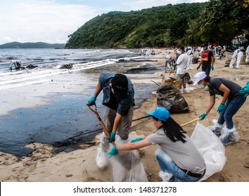 RAYONG -JUL 31: People clearing contaminated sand at the Aou Prow beach, Rayong, Thailand on Jul 31, 2013. The spilled oil came from the accidental leaking during oil tanker transferring on July 27. 