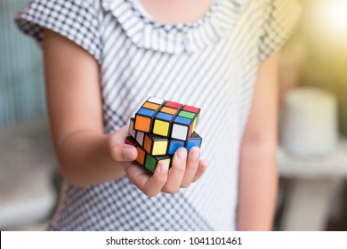 Rayong Province, Thailand - March 8th, 2018:  Kids Hands Plaiyng With The Rubik's Cube. Rubik's Cube Invented By A Hungarian Architect Erno Rubik In 1974.