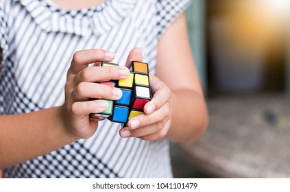 Rayong Province, Thailand - March 8th, 2018:  Kids Hands Plaiyng With The Rubik's Cube. Rubik's Cube Invented By A Hungarian Architect Erno Rubik In 1974.