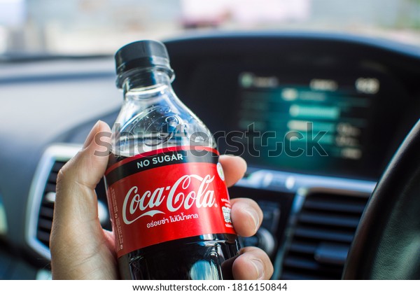 Rayong,Thailand - Sep 17, 2020  Coca\
cola brand , Coke zero no sugar in a driver hand inside the\
car