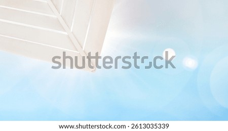rays of bright sun shining through beach umbrella, summer background