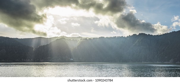 Rays And Clouds At A Lake