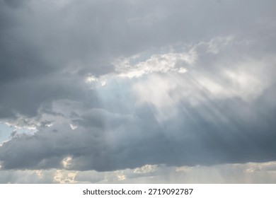 Rays of light breaking through the clouds.