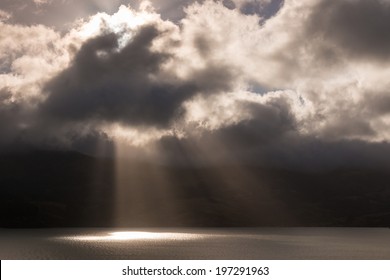 rays of light breaking through stormy clouds