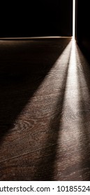 Rays of light from the door in a dark room