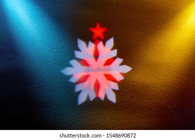 rays of light on a black background. Colored snowflakes and christmas trees