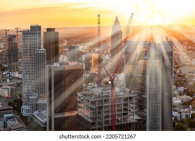 Rays of light from the setting evening sun over the skyscrapers of the banking district of Frankfurt am Main - Shutterstock ID 2205721267