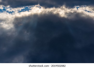 Rays of light shining throug dark clouds.Beautiful dramatic sky with sun rays.dramatic sky sun rays.