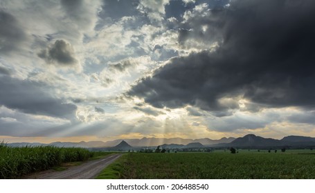 Rays Of Light Shining Through Dark Clouds . Dramatic Sky With Cloud 