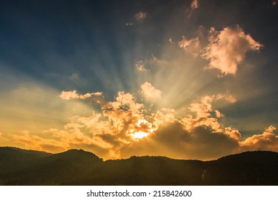 Rays Of Light Shining Through Dark Clouds For Background