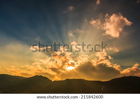 Rays of light shining through dark clouds for background