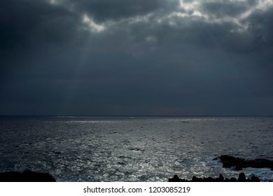 rays of light through the clouds falling on the sea