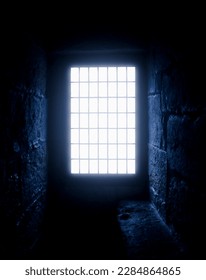 Rays of moonlight break through the narrow window of the old castle.