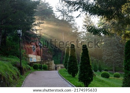 The rays of the morning sun in the park above the monument to Lenin in the city of Kislovodsk, Russia