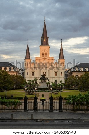 Rays from rising sun hit the facade of the Cathedral of St Louis, King of France with statue of Andrew Jackson in New Orleans in Louisiana