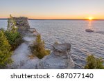 Rays of the setting sun highlight a ship cruising past Miners Castle on Lake Superior, near Munising, Michigan.