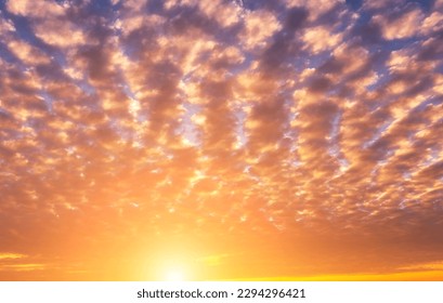 The rays of the sun breaking through the dramatic clouds in the evening or in the morning in the sunset or dawn sky. The concept of faith, hope for the best or good weather.