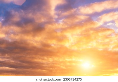 The rays of the sun breaking through the dramatic clouds in the evening or in the morning in the sunset or dawn sky. The concept of faith, hope for the best or good weather.