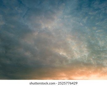 The rays of the sun breaking through the dramatic clouds in the evening or in the morning in the sunset or dawn sky. The concept of faith, hope for the best or good weather.