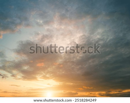 The rays of the sun breaking through the dramatic clouds in the evening or in the morning in the sunset or dawn sky. The concept of faith, hope for the best or good weather.